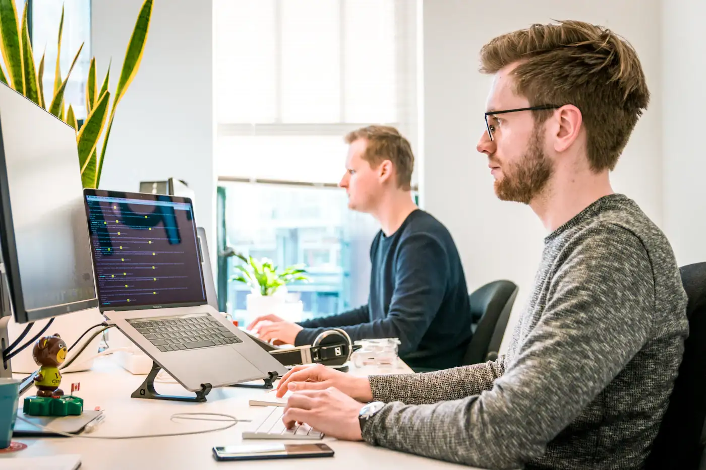 Colleagues collaborating at their desks